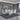 White extending dining table with six chrome leg chairs, ideal for family meals and entertaining guests.